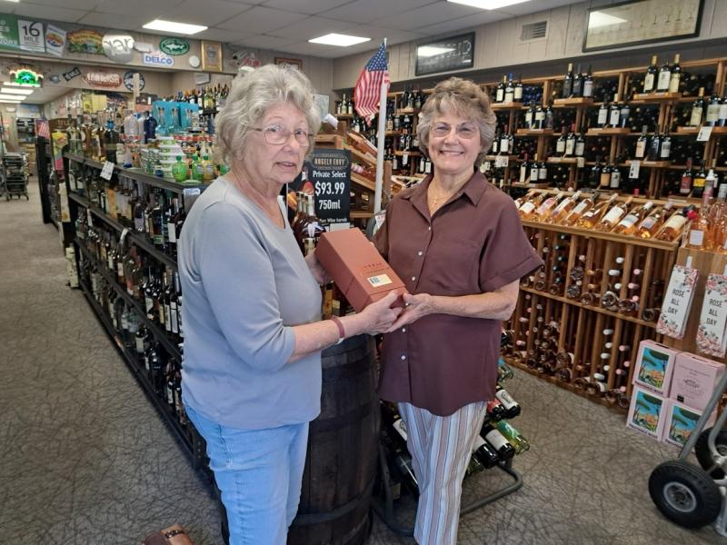 R&L Liquors Manager Carol Garner, left, is shown with Retta Frampton, winner of the rare bottle of Barrell Craft Bourbon that was raffled to support the purchase of the Fourth Street Preserve. SUBMITTED PHOTO